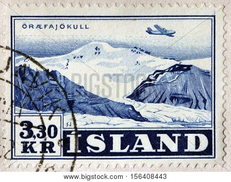 LUGA RUSSIA - NOVEMBER 6 2016: A stamp printed by ICELAND shows view of Oraefajokull - an ice-covered volcano in south-east Iceland circa 1952
