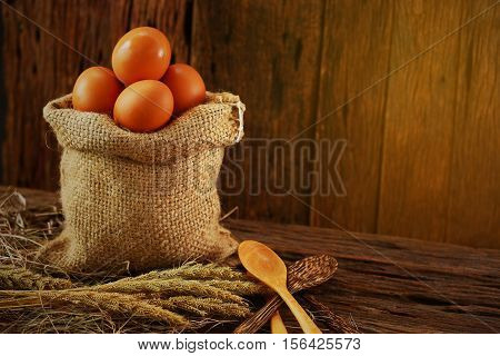 Fresh eggs on wooden background from farm and prepare for cook in kitchen room, Organic food and clean food for healthy, Eggs from farm to the market for raw material to cooking by chef in restaurant.