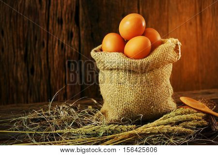 Fresh eggs on wooden background from farm and prepare for cook in kitchen room, Organic food and clean food for healthy, Eggs from farm to the market for raw material to cooking by chef in restaurant.