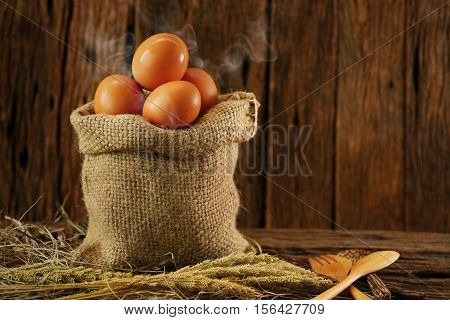 Fresh eggs on wooden background from farm and prepare for cook in kitchen room, Organic food and clean food for healthy, Eggs from farm to the market for raw material to cooking by chef in restaurant.