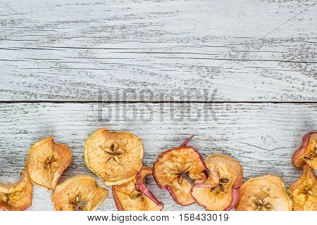 Dried apple slices on white wooden table. top view. copy space