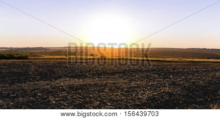 Sunset over the plowed field for planting
