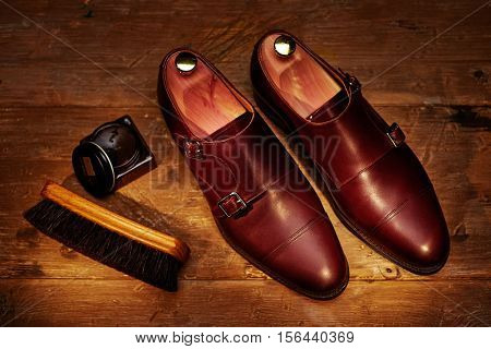 Still life with men's leather shoes and accessories for shoes care