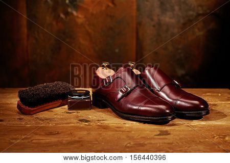 Still life with men's leather shoes and accessories for shoes care