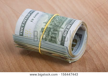 Hundred dollar bills tied with rubber band