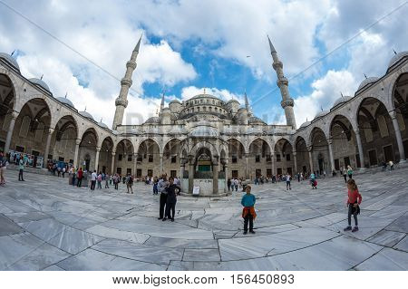 ISTANBUL TURKEY - JUNE 19 2015: People visiting Sultan Ahmet Mosque (Turkish: Sultan Ahmet Camii) a historic mosque in Istanbul Turkey. The mosque is popularly known as the Blue Mosque for the blue tiles adorning the walls of its interior