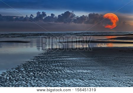 Super moon at sandy beach of the Baltic Sea,