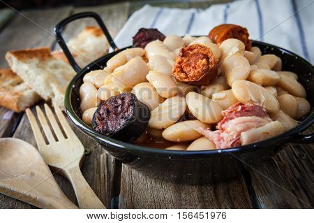 fabada is a typhical spanish legumes dish with big beans and sausage