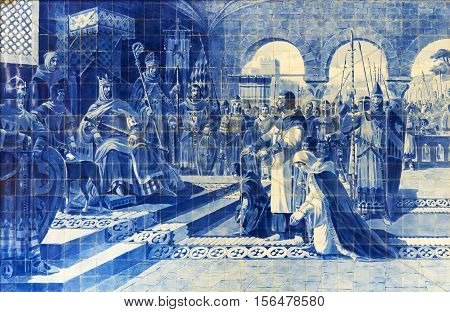Porto Portugal - October 13 2016: Azulejo panel in the Sao Bento railway station painted by Jorge Colaco. Egas Moniz to voluntarily turned himself in to the king of Castile and Leon Alfonso VII