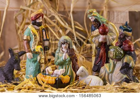 Christmas Manger scene with figurines including Jesus Mary and magi. Focus on Mary!
