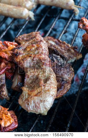 Burnt grill pork on dirty stove show smoke and dark chacoal. some point are raw medium on cancer cause.