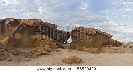 massive orange granite rock formation in sunset, Namibia
