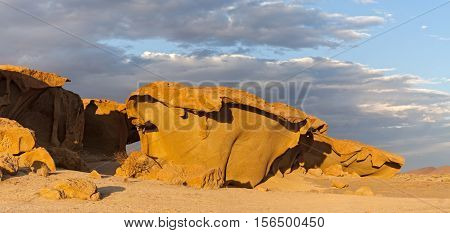 massive orange granite rock formation in sunset, Namibia