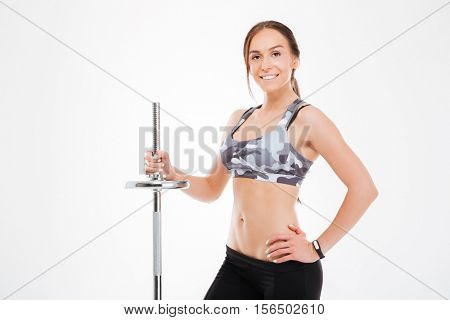 Smiling fitness girl with barbell. looking at camera. isoolated wite background