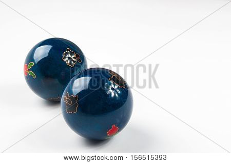 pair of blue Chinese singing balls Baoding of health for hands on white background