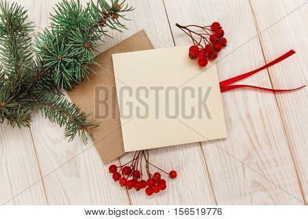 Christmas mokup.Tree branch frame empty cards with rowanberry .White wooden table.