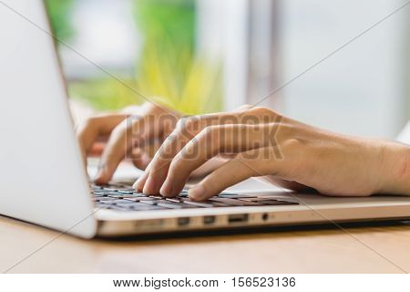 Put fingers on the keyboard of labtop with vintage style.