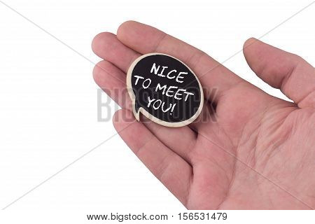hand holding a wooden black speech bubble with nice to meet you text on it isolated on white