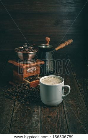Coffee Cup, Mill And Jezve On Dark Rustic Table