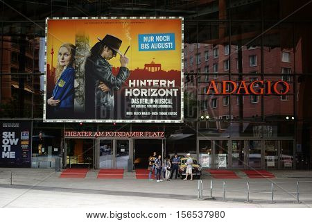 BERLIN, GERMANY - JUNE 21: Theater visitors standing next to a car of the brand Trabant at the entrance portal of the Theater at the Potsdam Square on June 21, 2016 in Berlin.