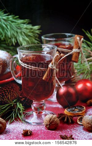 Christmas table setting. Bundt cake pudding sprinkled with sugar powder decorated with red currant and mulled wine.