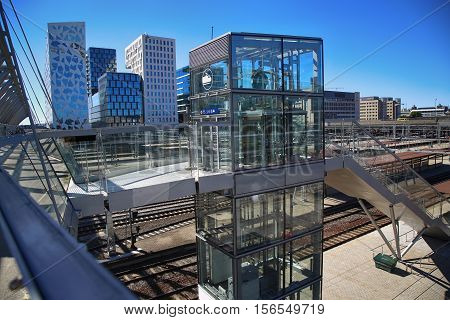 OSLO NORWAY - AUGUST 17 2016: View of Akrobaten pedestrian bridge with modern business architecture and elevator lift that leads to the railway station street in Oslo Norway on August 17 2016.