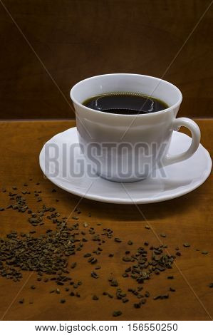 Porcelan cup of coffee on the brown table