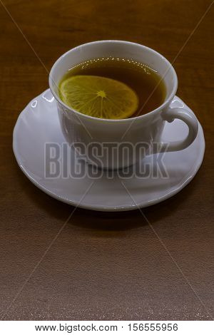 Porcelan cup of tea on the brown table