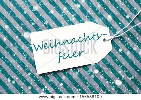 German Text Weihnachtsfeier Means Christmas Party. One Label On A Turquoise Striped Wrapping Paper. Textured Background With Snowflakes. Tag With Ribbon.