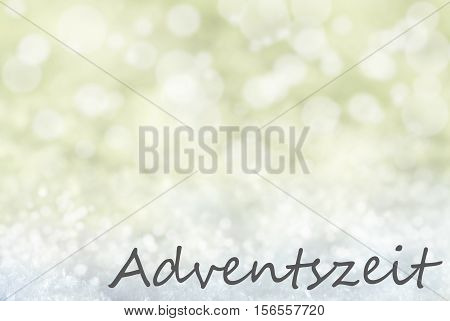 German Text Adventszeit Means Advent Season. Golden Bokeh Christmas Background Or Texture With Snow. Copy Space For Your Text Here