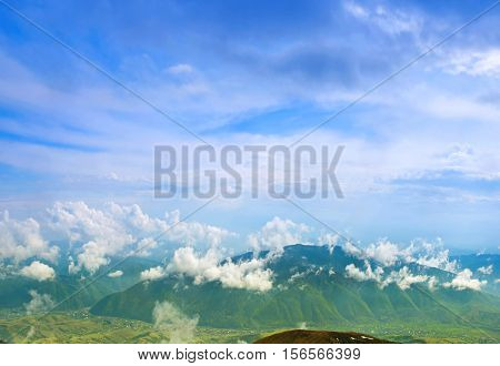 Landscape with clouds mountains blue sky and village. Carpathians Ukraine.