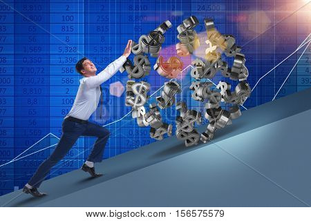 Businessman pushing away dollar ball