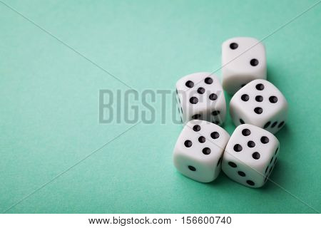 White dice on green table. Gambling devices. Copy space for text. Game of chance concept.