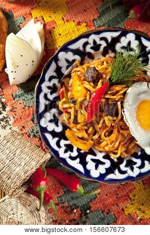 Asian Style Noodles with Meat and Laghman Sauce. Garnished with Fried Egg