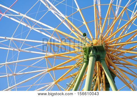 Ferris wheel close up with blue sky in amusement park