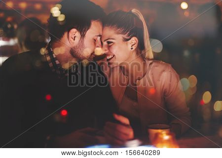 Romantic couple dating in pub at night