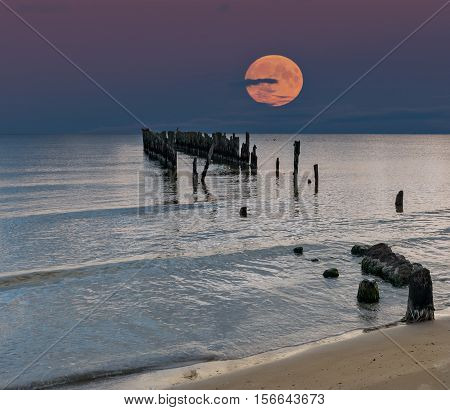 Rise of  Super moon, Baltic Sea, remains of old fishery pier