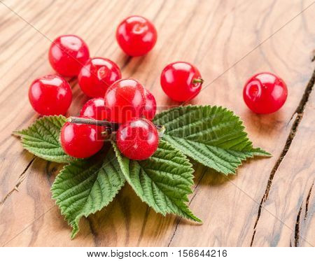 Nanking or felted cherry ftuits with leaves on the wooden table.