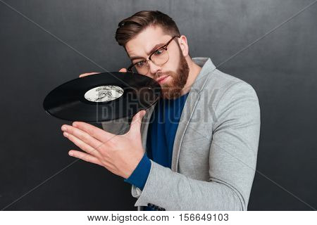 Man with vynil. vynil near the face. isolated black background