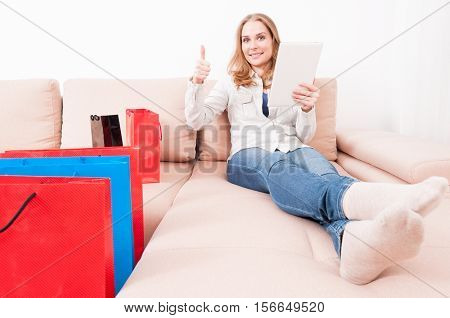 Woman Laying On Chouch With Tablet Showing Like