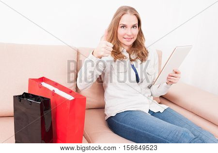 Lady Laying On Chouch Holding Tablet Showing Like
