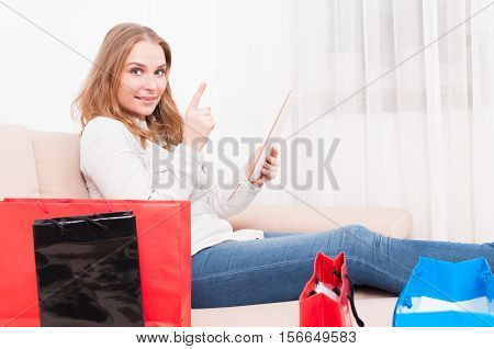 Lady Laying On Chouch Holding Tablet Showing Idea Gesture