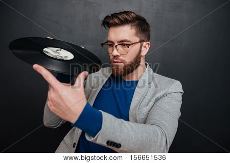 Rock star with vynil in studio. isolated black background
