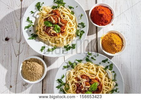Pasta dinner for two people on old wooden table