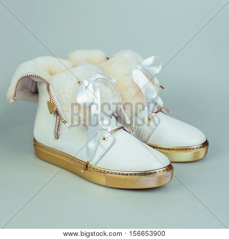 stylish female white shoes in grey background
