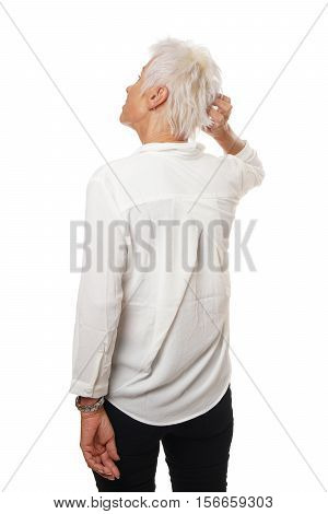 Rear view of older woman scratching her head, isolated on white.