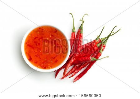 Red chili peppers and chili sauce isolated on white background.