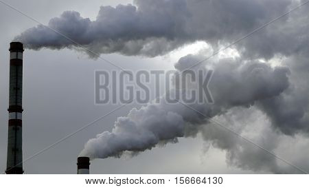 industrial chimneys emits toxic pollutants into the sky polluting the environment
