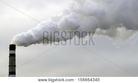 industrial chimneys emits toxic pollutants into the sky polluting the environment