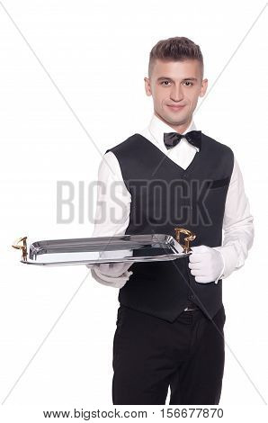 A waiter or bartender or servant holding a silver tray and smiling. White background.